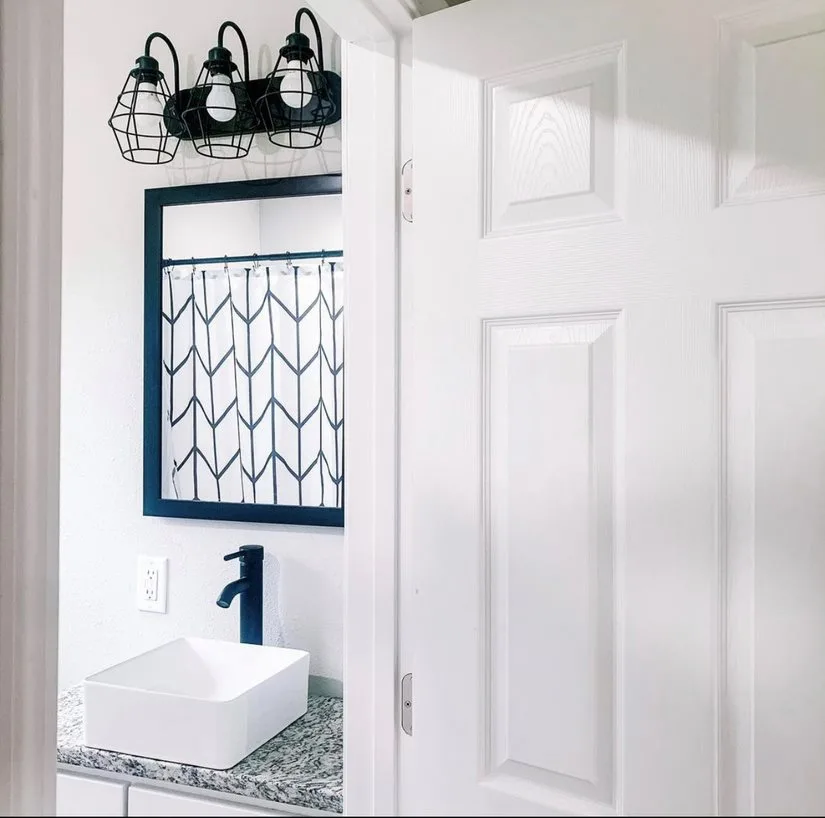 Finished bathroom with black and white design