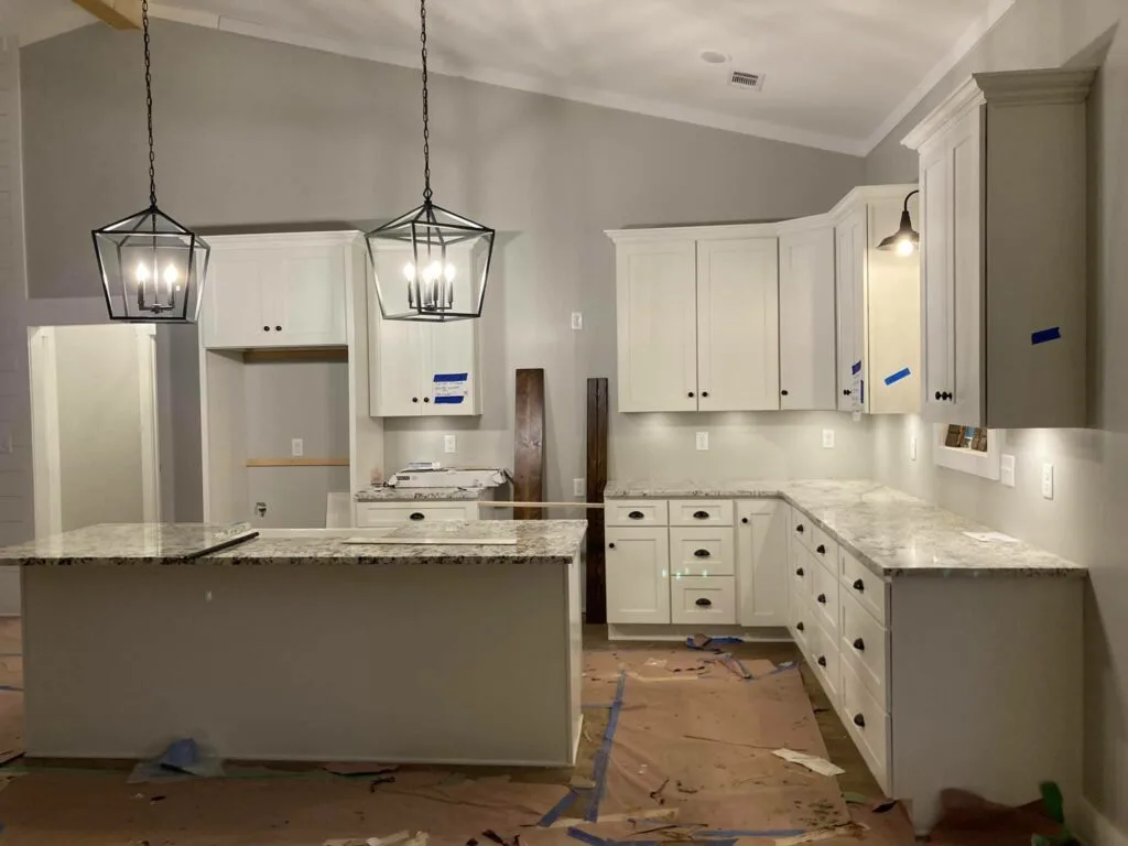 Kitchen including island, granite counters, and pendant lighting