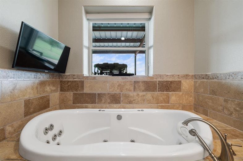 Jetted bath tub with television