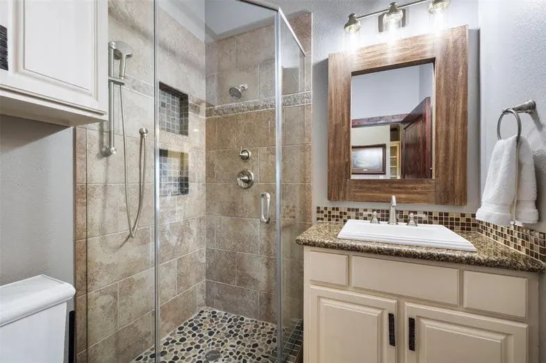 bathroom with tiled shower