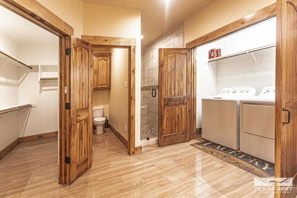 Bathroom with laundry closet, walk-in closet, and walk-in shower