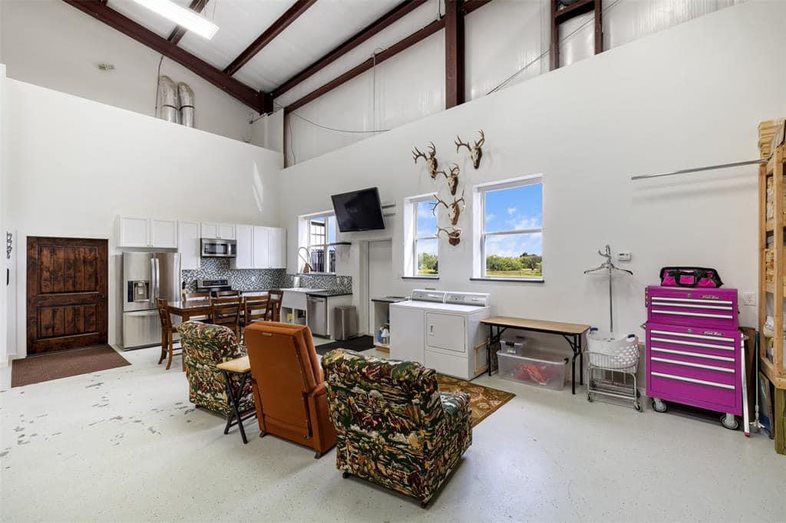 Garage laundry and kitchen area with full kitchen and television