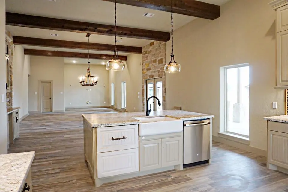 Dark stained wood beams across the open concept living space