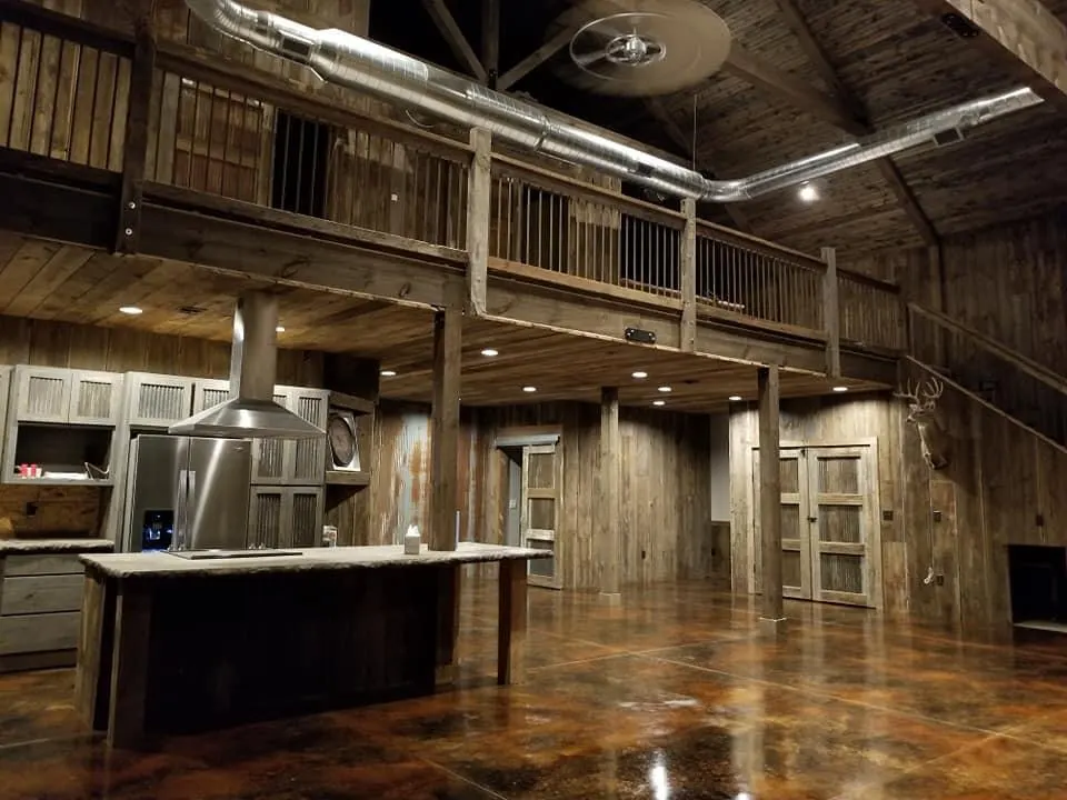 View of stained concrete floor, kitchen, and loft