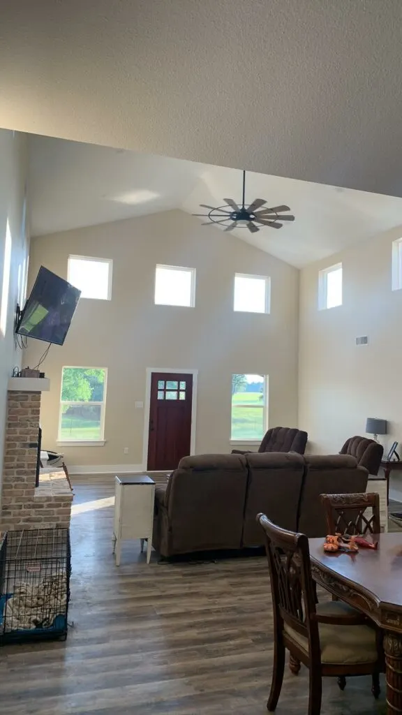 Barndominium Living Room with white painted walls and high ceiling