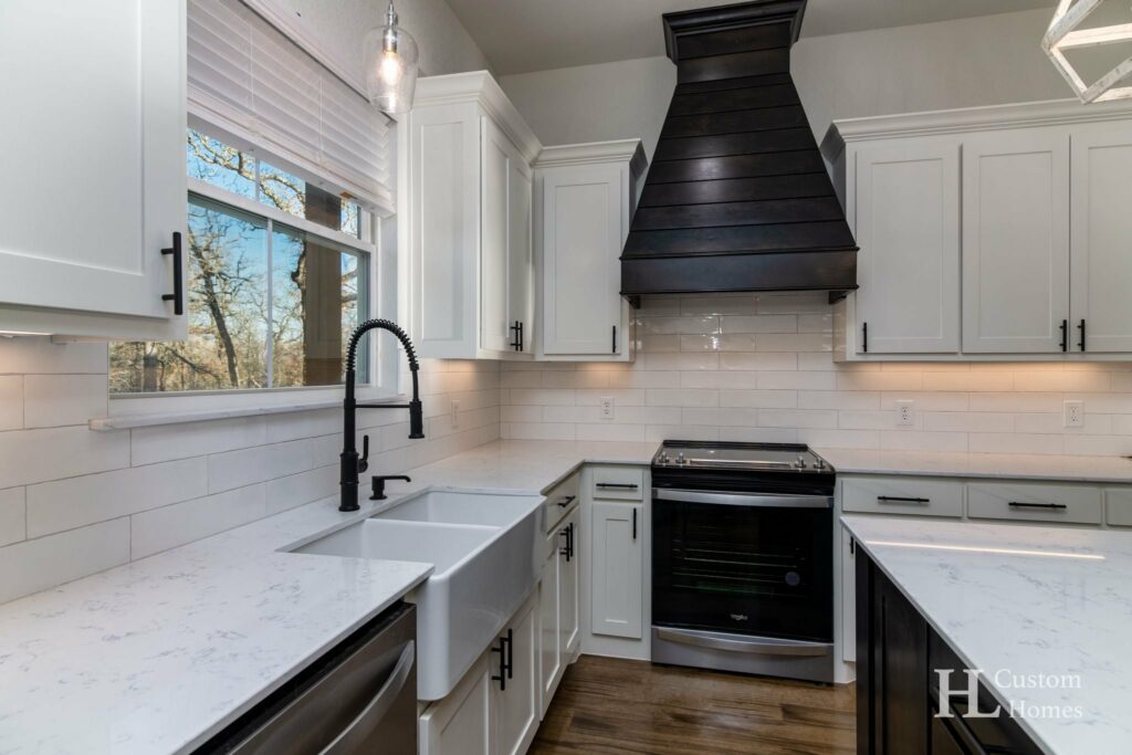White kitchen countertop; overhead and lower cabinets; and sink