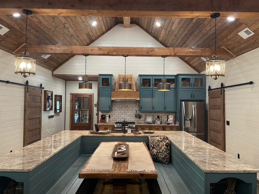 Large kitchen with timber beams inside a pole barn home in Iowa