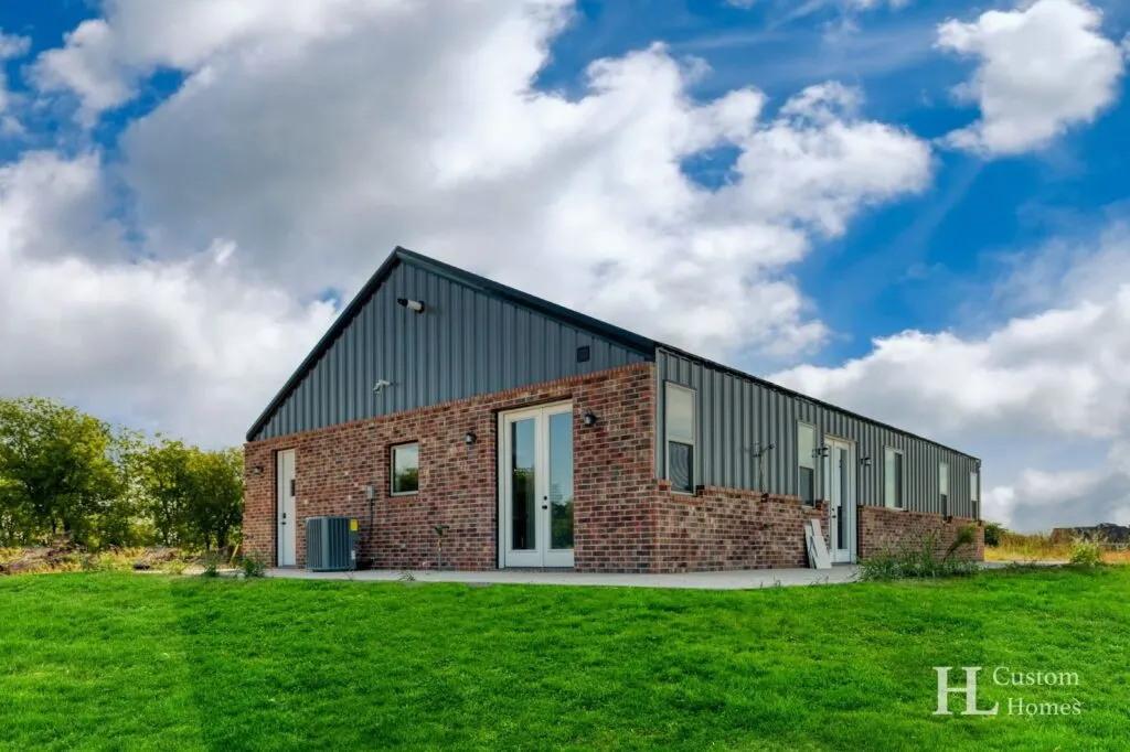 Krum House Barndominium with Brick Wainscot by HL Custom Homes